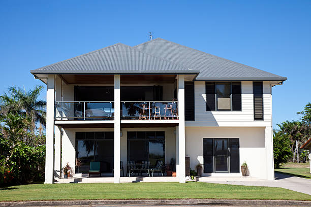 "Tidy two story family beach side home with blue sky and green grass, Queensland Australia. Click to see more..."